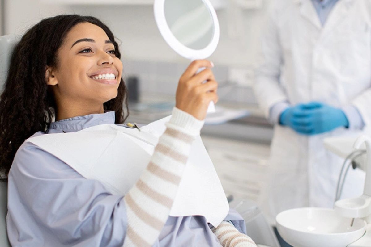 Patient smiling after effective treatment for tooth discoloration