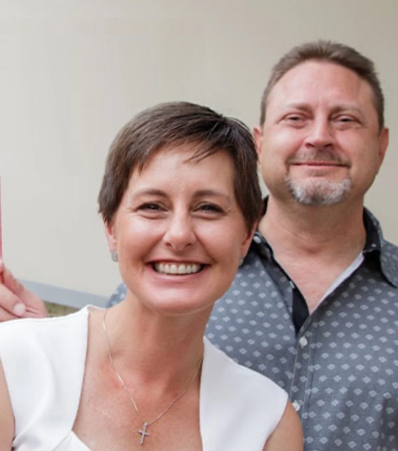 Two smiling dental professionals posing together indoors at Modern Dental of Kernersville.